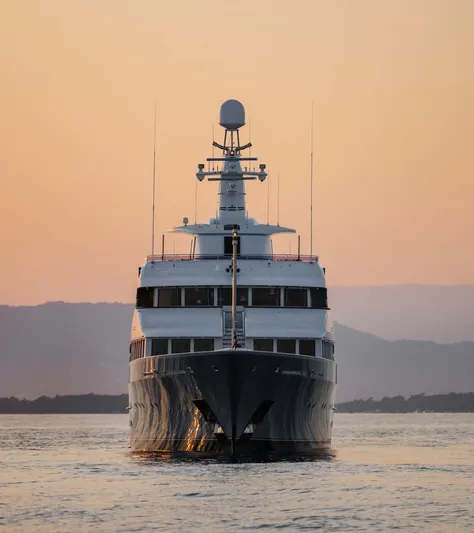 Olympus Yacht Photos Pics Feadship 1996 motor yacht at sunset, front view on calm water.