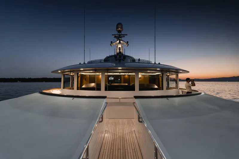Olympus Yacht Photos Pics Luxurious 1996 Feadship motor yacht at sunset, showcasing elegant design and serene waters.