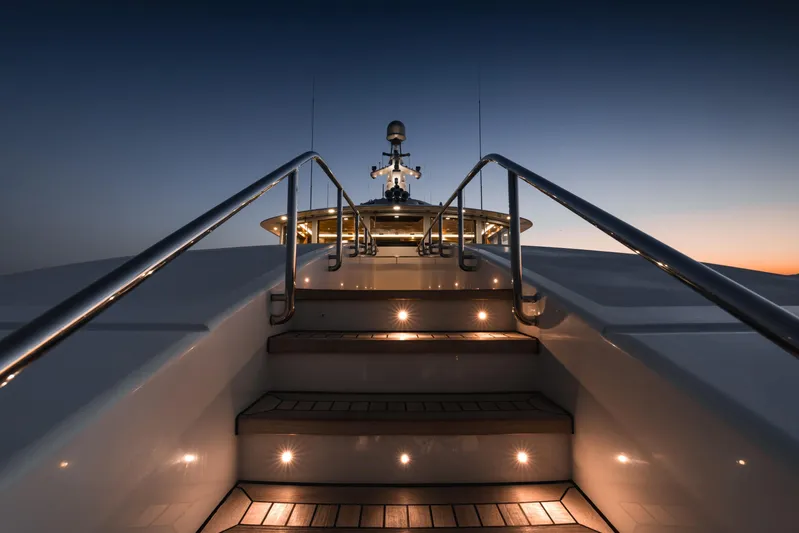 Olympus Yacht Photos Pics 1996 Feadship motor yacht stairs illuminated at dusk, showcasing luxury design.
