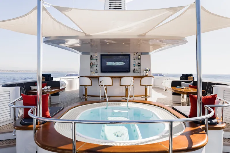 Olympus Yacht Photos Pics Luxurious 1996 Feadship motor yacht deck with jacuzzi and bar area.