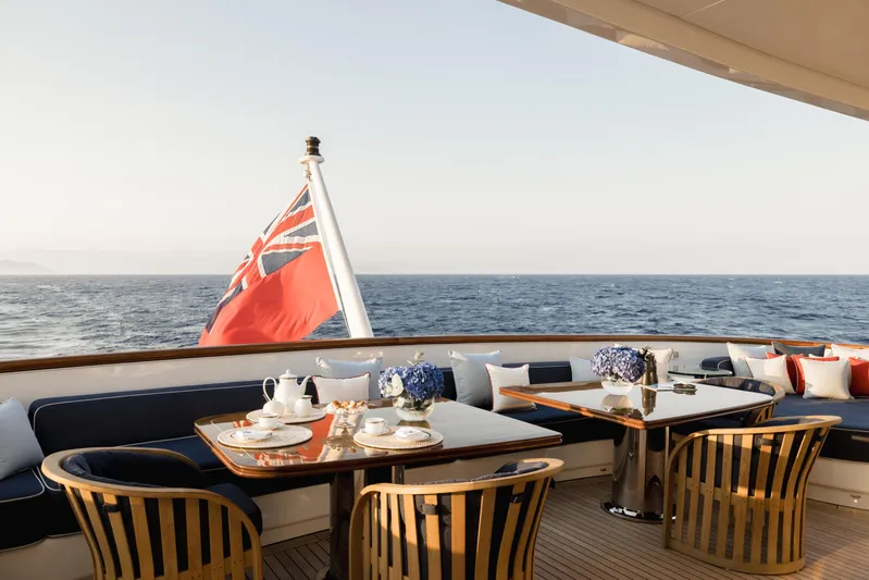 Olympus Yacht Photos Pics Luxurious 1996 Feadship motor yacht deck with elegant dining setup and ocean view.