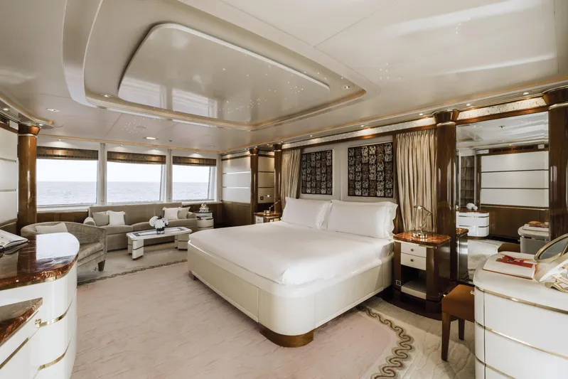 Olympus Yacht Photos Pics Luxurious bedroom interior of 1996 Feadship motor yacht with elegant furnishings and ocean view.