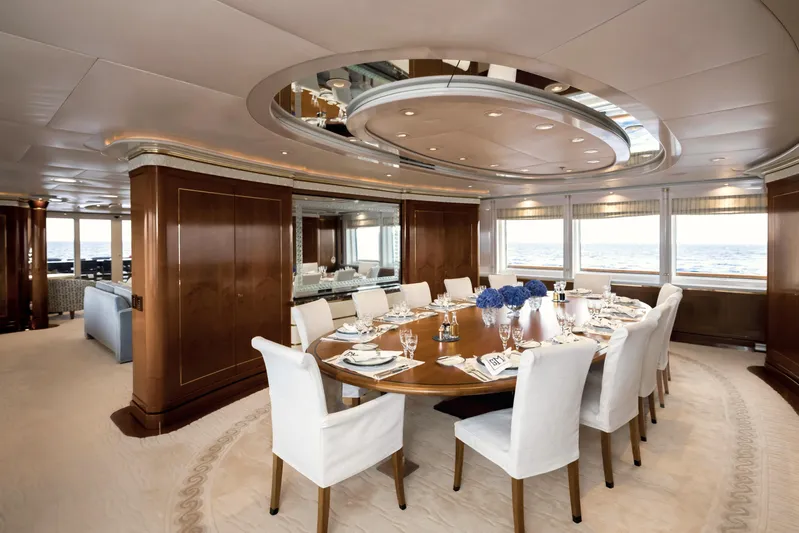 Olympus Yacht Photos Pics Luxurious dining area on a 1996 Feadship motor yacht with elegant decor and ocean views.