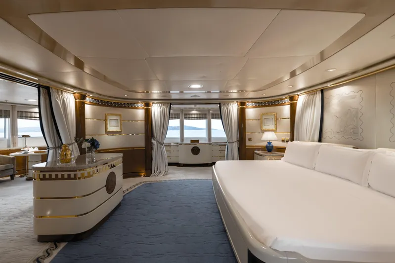 Olympus Yacht Photos Pics Luxurious 1996 Feadship motor yacht bedroom with elegant decor and ocean view.