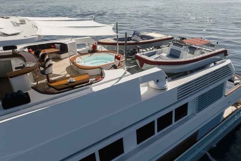 Olympus Yacht Photos Pics Luxurious 1996 Feadship motor yacht with deck jacuzzi and seating area on calm waters.