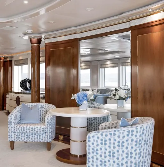 Olympus Yacht Photos Pics Luxurious interior of a 1996 Feadship motor yacht with elegant seating and floral decor.