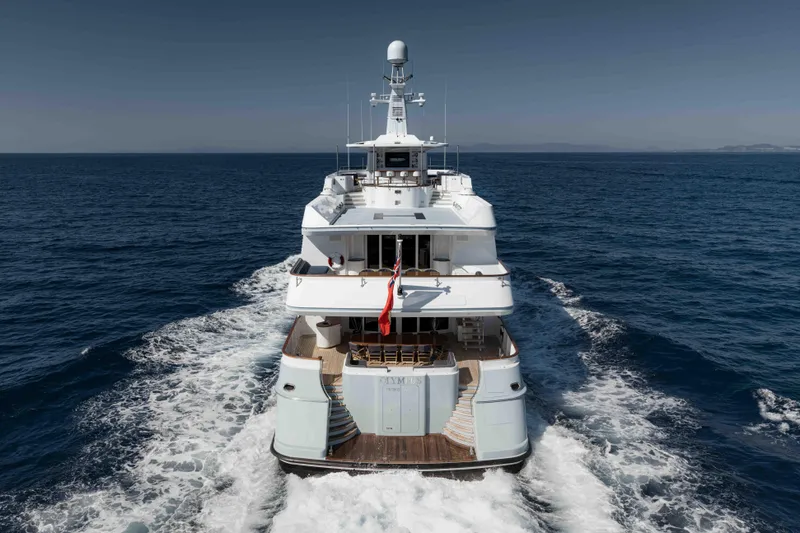 Olympus Yacht Photos Pics Feadship 1996 motor yacht cruising on open sea, rear view.