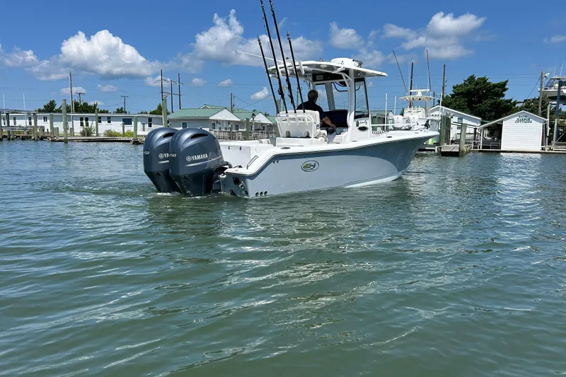  Yacht Photos Pics 2021 Sea Hunt Gamefish 25 boat with dual Yamaha engines on calm water.