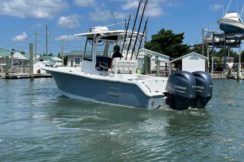  Yacht Photos Pics 2021 Sea Hunt Gamefish 25 boat with dual Yamaha engines in a marina setting.