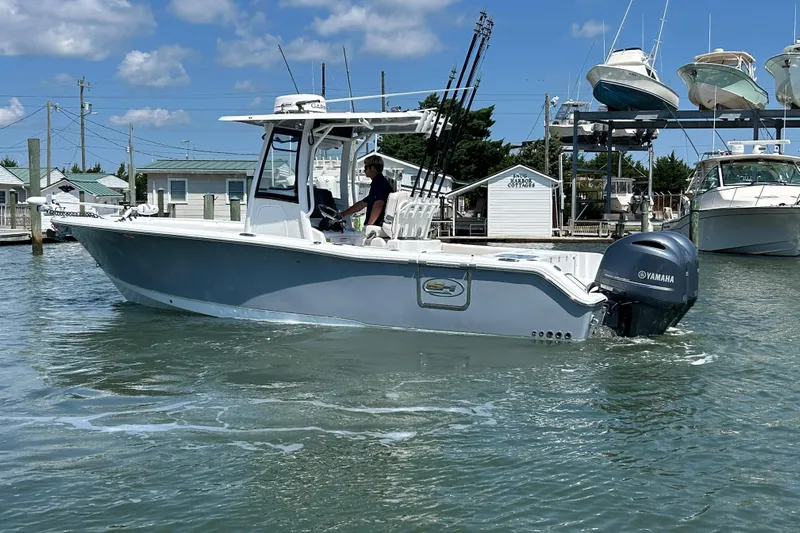 Yacht Photos Pics 2021 Sea Hunt Gamefish 25 boat with Yamaha engine in a marina setting.