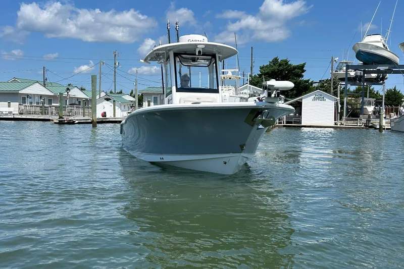  Yacht Photos Pics 2021 Sea Hunt Gamefish 25 boat docked in a marina under a clear blue sky.