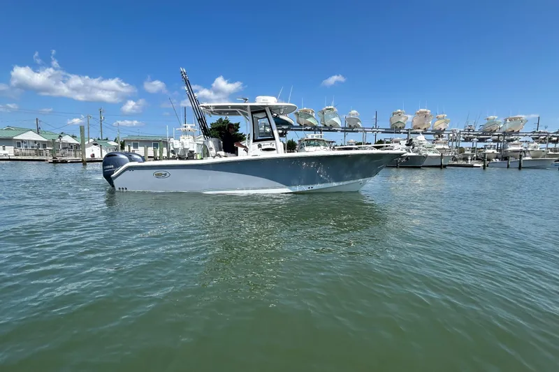 Yacht Photos Pics 2021 Sea Hunt Gamefish 25 boat on water, marina background, clear sky.