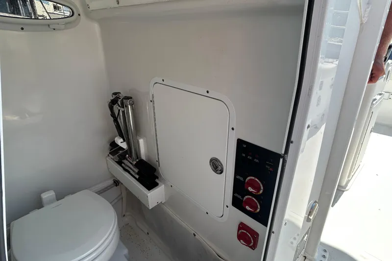  Yacht Photos Pics 2021 Sea Hunt Gamefish 25 interior with toilet and control panel.