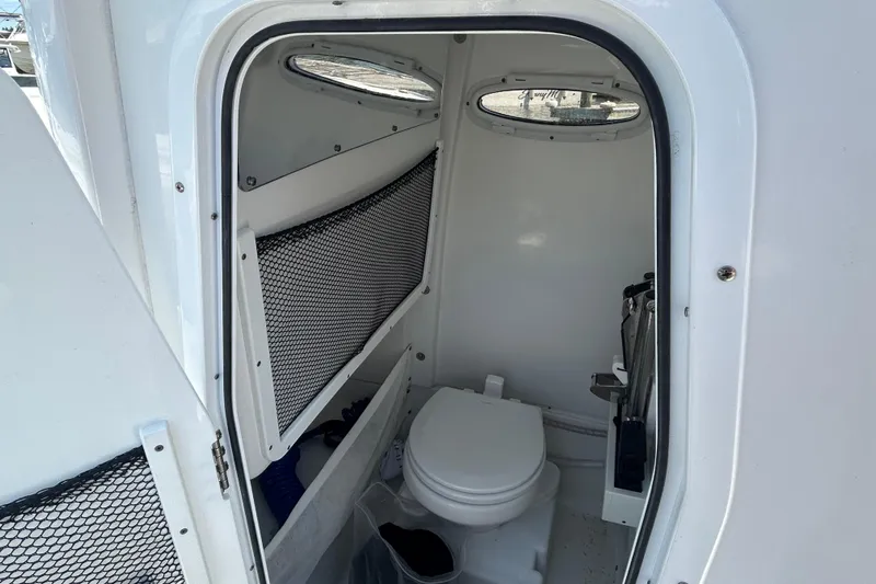  Yacht Photos Pics Interior view of 2021 Sea Hunt Gamefish 25 boat's compact bathroom with toilet.