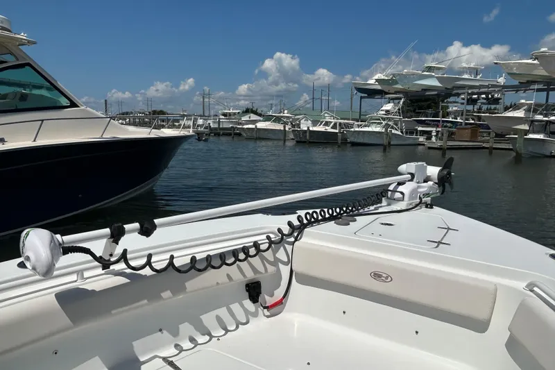  Yacht Photos Pics 2021 Sea Hunt Gamefish 25 boat docked at marina under clear blue sky.
