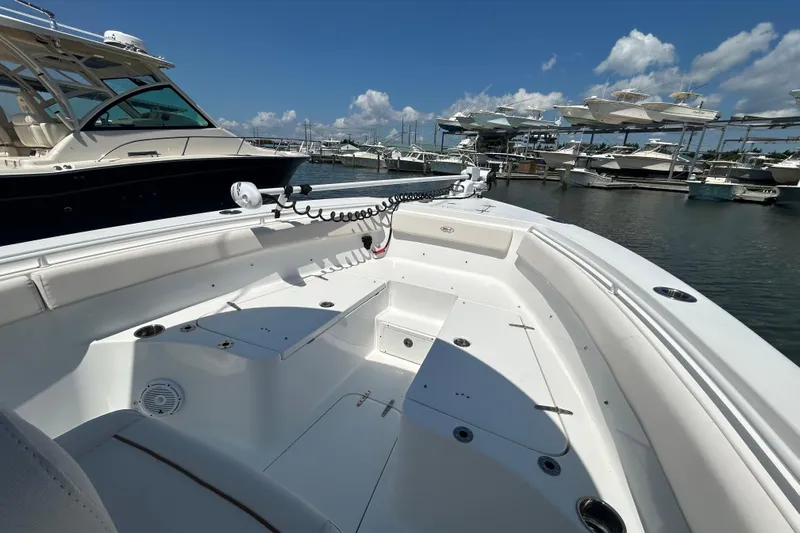  Yacht Photos Pics 2021 Sea Hunt Gamefish 25 boat docked at marina, clear sky, multiple boats in background.