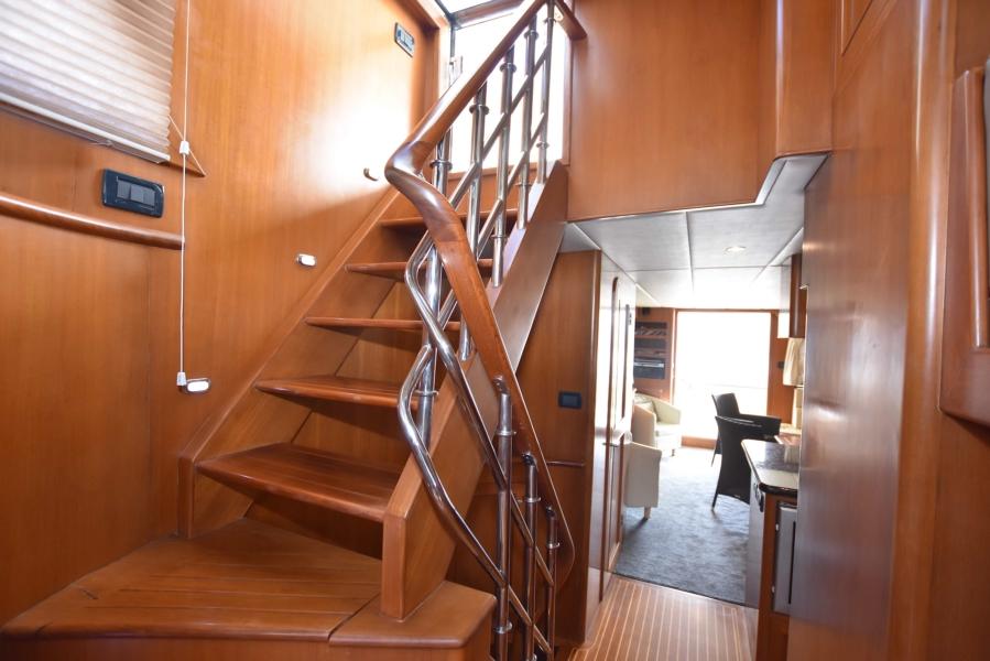 Interior of 2009 Explorer 64' Trawler Grand Alaskan with wooden staircase and modern design.