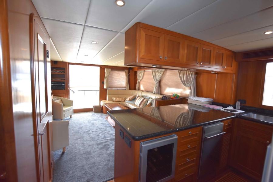 Luxurious interior of 2009 Explorer 64' Trawler Grand Alaskan yacht with modern kitchen and seating area.