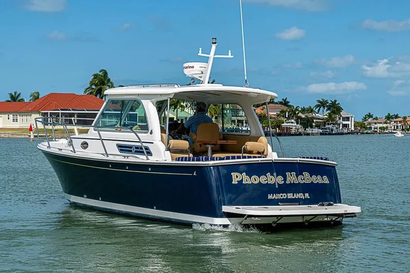 Phoebe Mcbean Yacht Photos Pics 2011 Back Cove 30 boat cruising near Marco Island, Florida, with clear skies and waterfront homes.