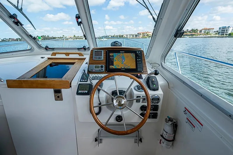 Phoebe Mcbean Yacht Photos Pics 2011 Back Cove 30 boat helm with navigation equipment and steering wheel on open water.