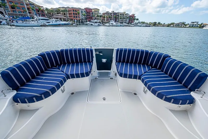 Phoebe Mcbean Yacht Photos Pics 2011 Back Cove 30 boat with striped seating, docked in a scenic marina.
