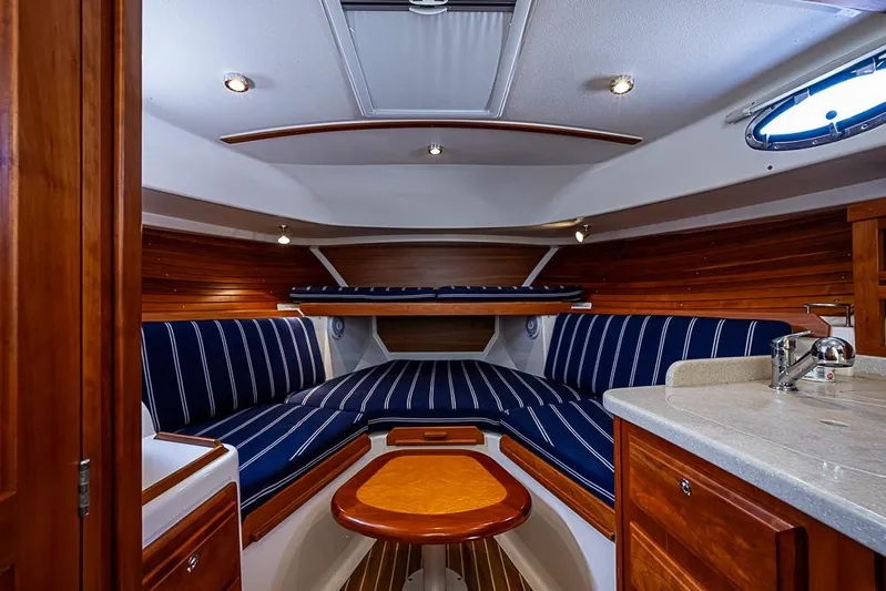 Phoebe Mcbean Yacht Photos Pics Interior of 2011 Back Cove 30 boat with striped seating and wooden accents.