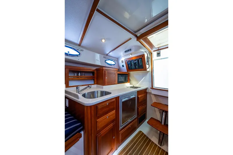 Phoebe Mcbean Yacht Photos Pics 2011 Back Cove 30 yacht interior with modern kitchen, wood cabinetry, and stainless steel sink.