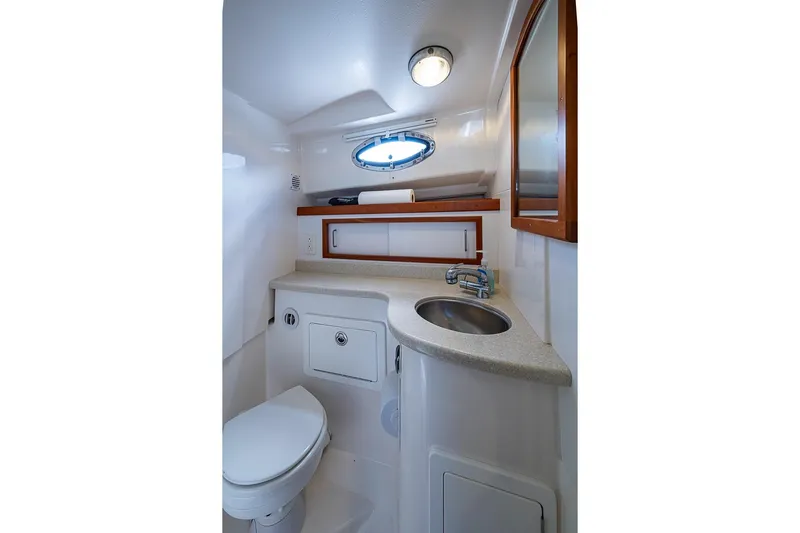 Phoebe Mcbean Yacht Photos Pics 2011 Back Cove 30 yacht bathroom with sink, toilet, and porthole window.