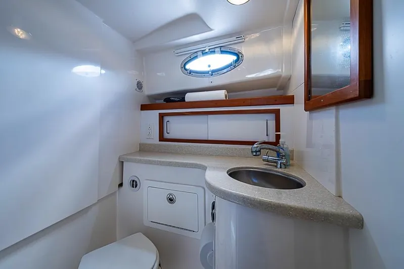 Phoebe Mcbean Yacht Photos Pics 2011 Back Cove 30 yacht bathroom with sink, mirror, and storage cabinet.