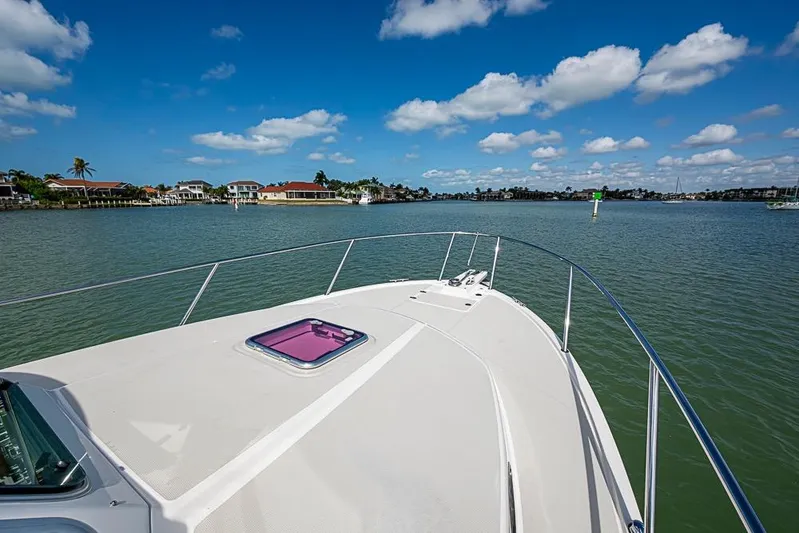 Phoebe Mcbean Yacht Photos Pics Bow view of 2011 Back Cove 30 boat on calm water under blue sky.