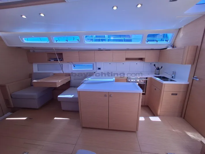  Yacht Photos Pics Interior of 2019 Grand Soleil 52 LC Sport yacht with modern kitchen and seating area.