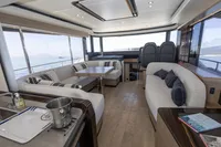 Luxurious interior of 2021 Absolute 52 Navetta yacht with elegant seating and ocean views.