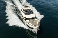 2021 Absolute 52 Navetta yacht cruising on open water, aerial view.