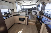 Luxurious interior of 2021 Absolute 52 Navetta yacht with modern kitchen and seating area.
