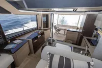 Luxurious interior of 2021 Absolute 52 Navetta yacht with modern kitchen and ocean view.