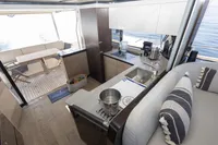 Modern kitchen and dining area on 2021 Absolute 52 Navetta yacht, featuring sleek design and ocean view.