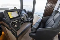Cockpit of 2021 Absolute 52 Navetta yacht with navigation screens and leather seating.