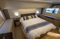 Luxurious bedroom interior of 2021 Absolute 52 Navetta yacht with elegant bedding and modern design.
