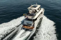 Luxury yacht Absolute 52 Navetta 2021 cruising on open sea, rear view.