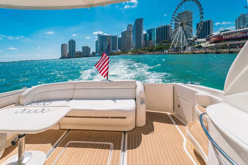  Yacht Photos Pics Luxurious 2002 Sea Ray 510 Sundancer yacht cruising with city skyline and Ferris wheel view.