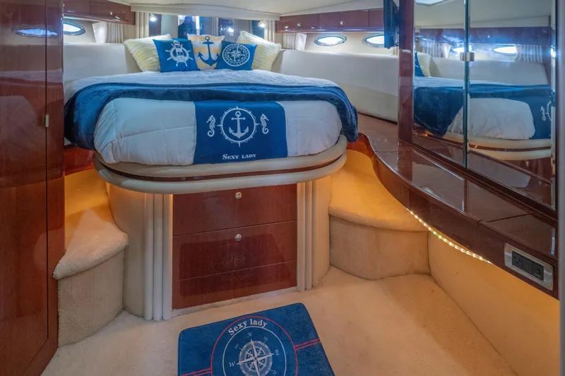  Yacht Photos Pics Luxurious bedroom interior of 2002 Sea Ray 510 Sundancer yacht with nautical decor.