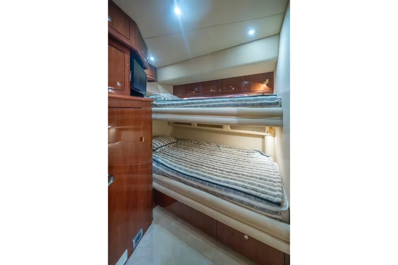  Yacht Photos Pics Interior of 2002 Sea Ray 510 Sundancer with cozy bunk beds and wooden cabinetry.
