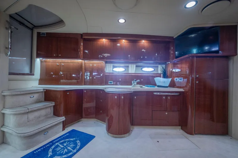  Yacht Photos Pics Luxurious interior of 2002 Sea Ray 510 Sundancer yacht with polished wood cabinetry.