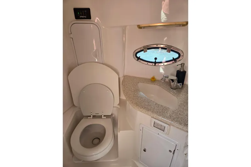 Let's Go! Yacht Photos Pics 2007 Fountain 38 Express Cruiser bathroom with toilet, sink, and porthole window.