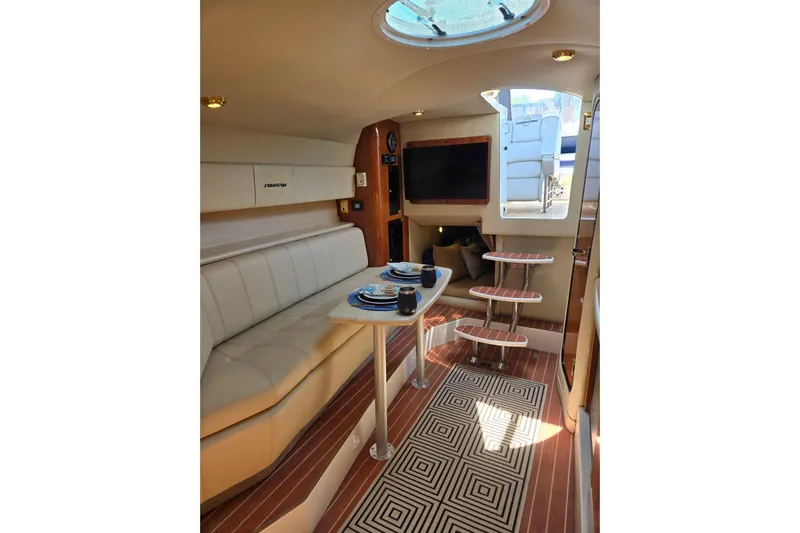Let's Go! Yacht Photos Pics Luxurious interior of 2007 Fountain 38 Express Cruiser with elegant seating and dining area.
