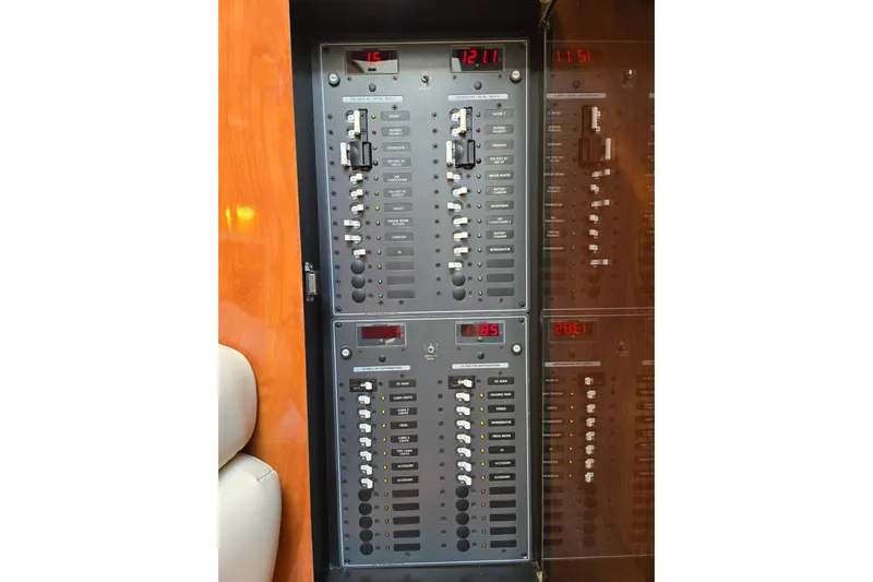 Let's Go! Yacht Photos Pics Electrical panel of a 2007 Fountain 38 Express Cruiser boat, featuring switches and digital displays.