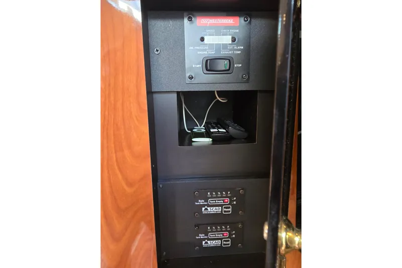 Let's Go! Yacht Photos Pics Control panel inside 2007 Fountain 38 Express Cruiser, featuring gauges and switches.