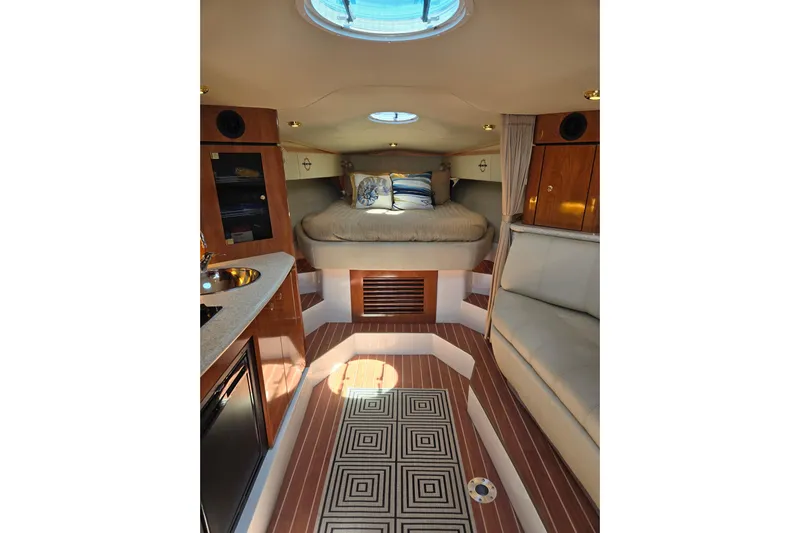 Let's Go! Yacht Photos Pics Interior of 2007 Fountain 38 Express Cruiser with cozy bed and modern amenities.