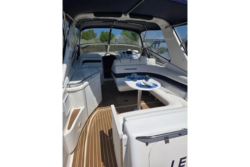 Let's Go! Yacht Photos Pics 2007 Fountain 38 Express Cruiser interior with seating, table, and helm.