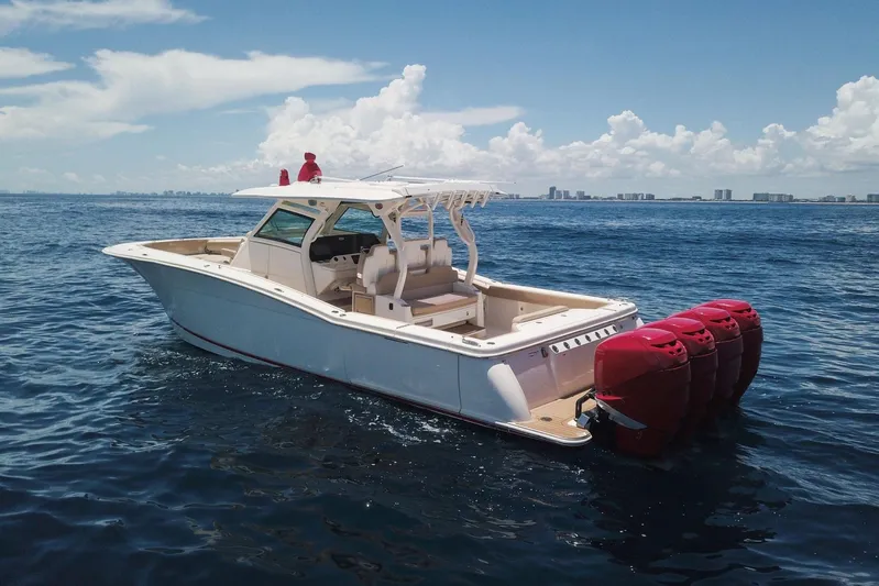 Yacht Photos Pics 2020 Scout 380 LXF boat with red engines on open water under blue sky.